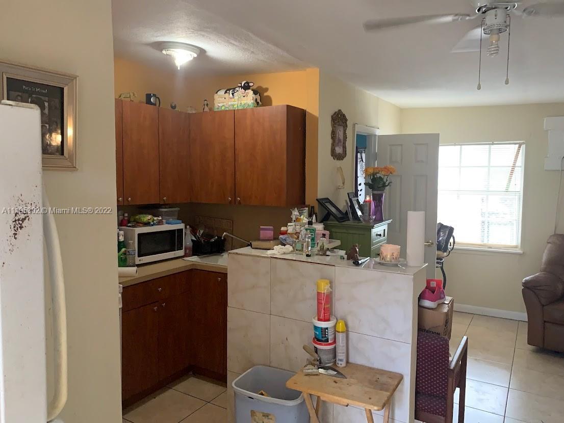 3040 Northwest 13th Avenue Miami, FL 33142 - Photo 41 of 51 a kitchen with a sink stove and refrigerator