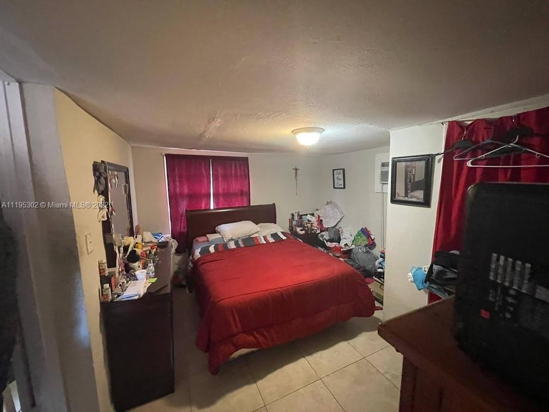 3040 Northwest 13th Avenue Miami, FL 33142 - Photo 42 of 51 a bedroom with a bed and dresser