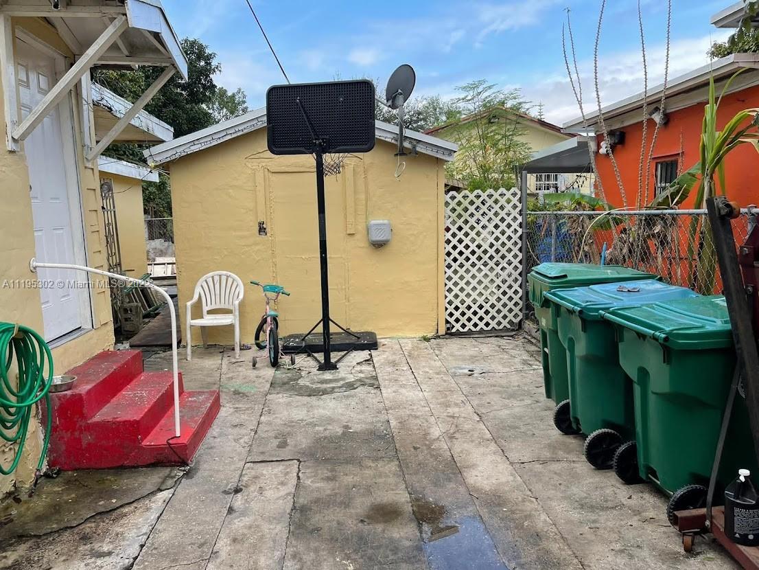 3040 Northwest 13th Avenue Miami, FL 33142 - Photo 46 of 51 a view of a chairs and table in backyard