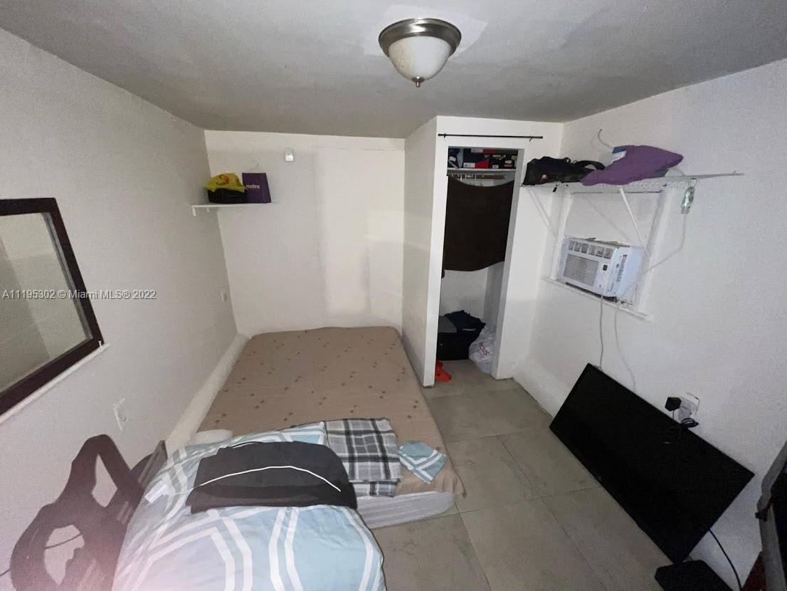 3040 Northwest 13th Avenue Miami, FL 33142 - Photo 48 of 51 a bedroom with a bed and a black furniture