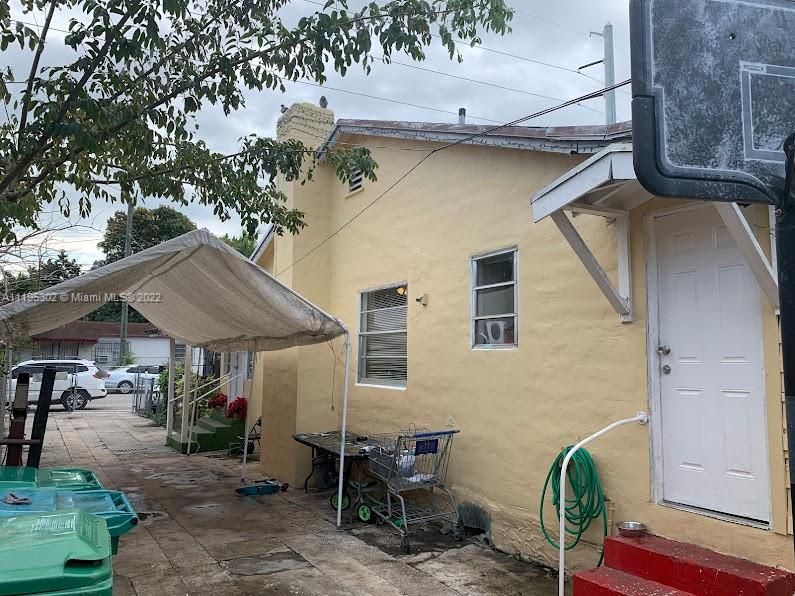 3040 Northwest 13th Avenue Miami, FL 33142 - Photo 5 of 51 a view of patio with table and chairs under an umbrella