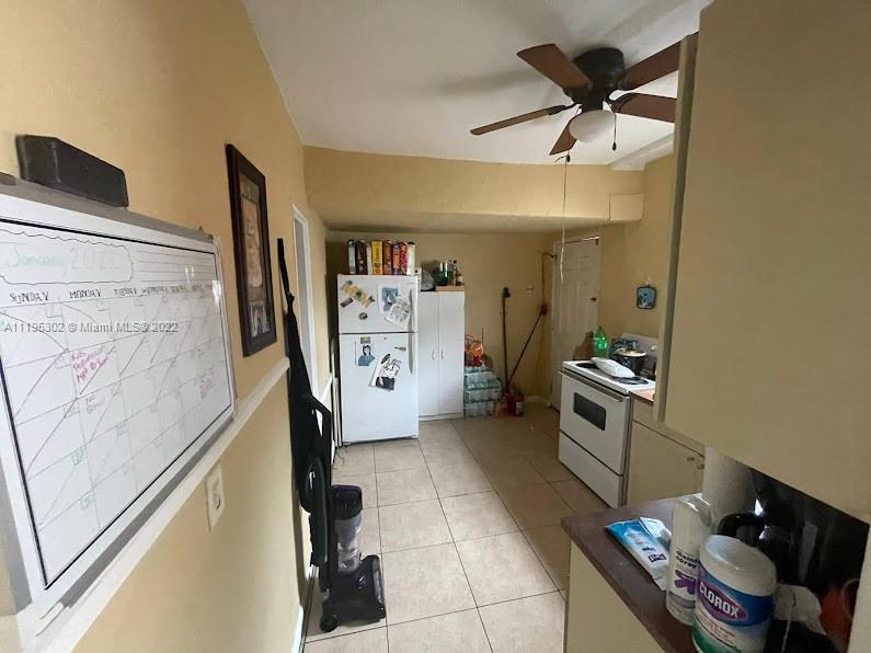 3040 Northwest 13th Avenue Miami, FL 33142 - Photo 7 of 51 a kitchen with stainless steel appliances a refrigerator and a stove top oven