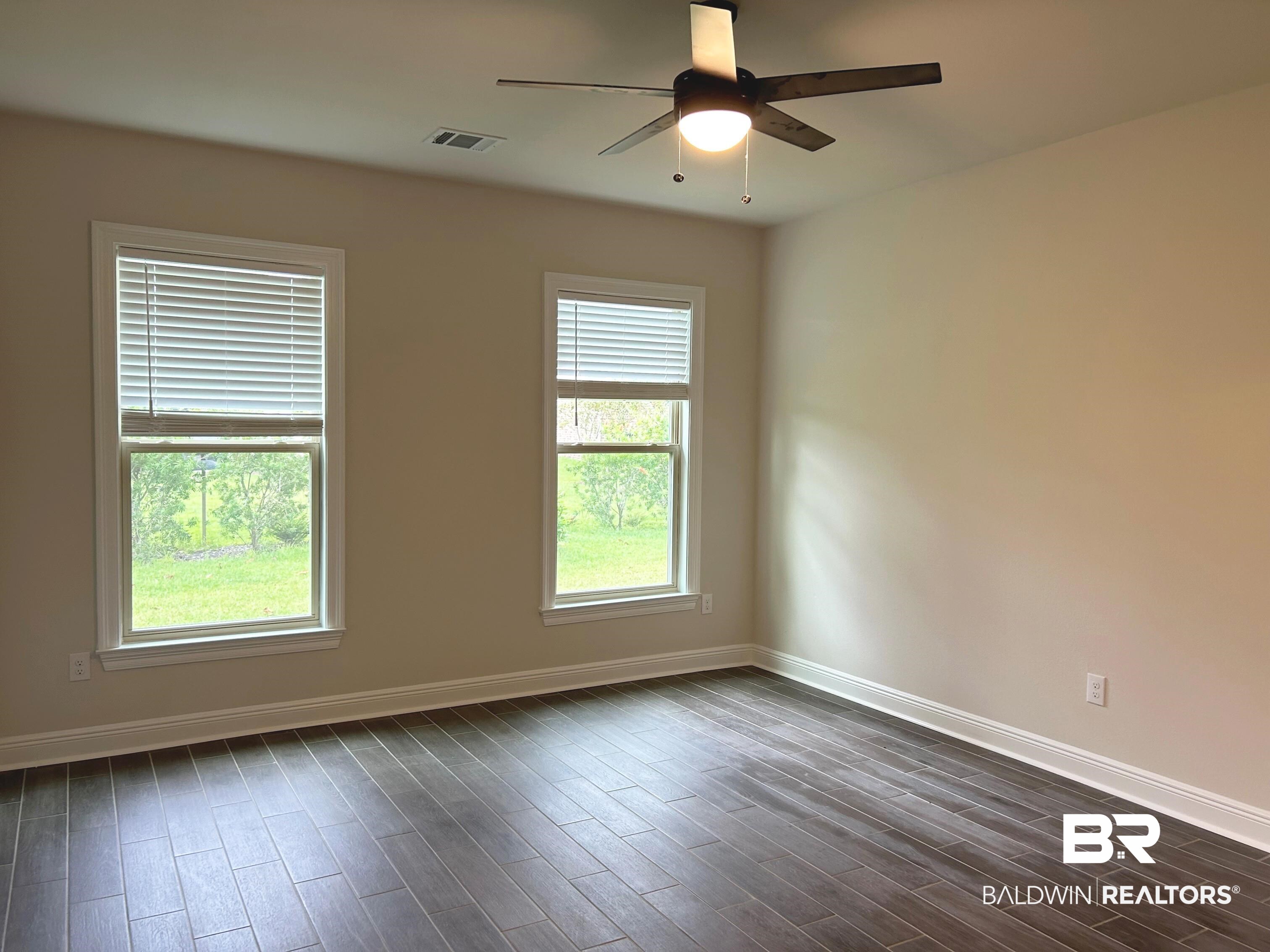 844 Sumter Loop Foley, AL 36535 - Photo 7 of 18 Unfurnished room featuring ceiling fan and dark hardwood / wood-style flooring