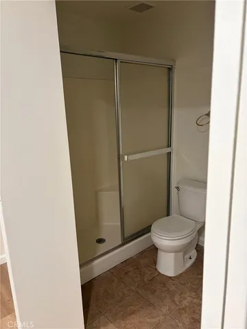 a bathroom with a toilet and a shower