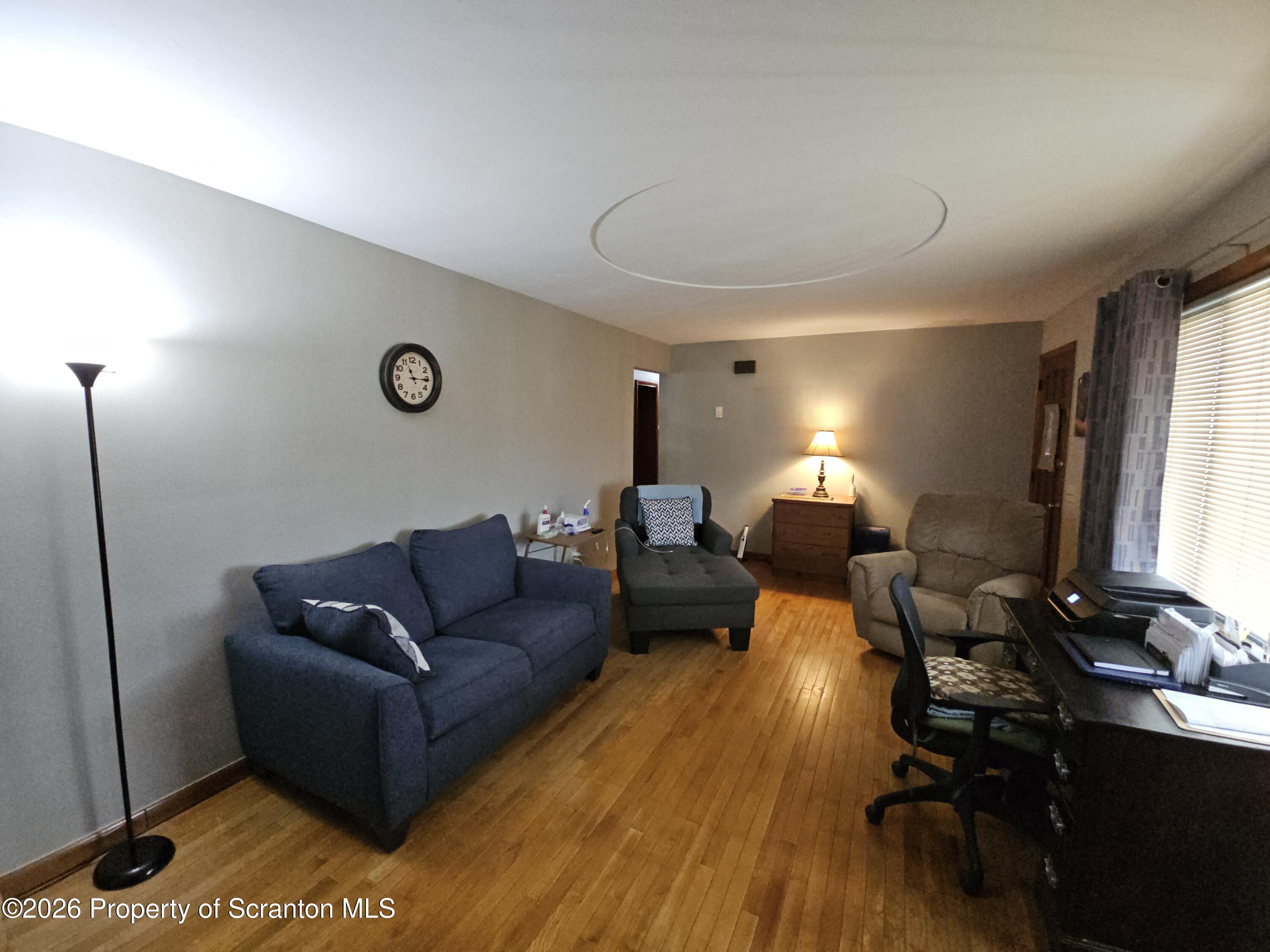 405 Baker Street Taylor, PA 18517 - Photo 15 of 36 a living room with furniture lamp and a window
