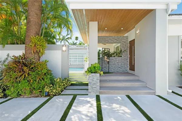 a view of a pathway with flower plants