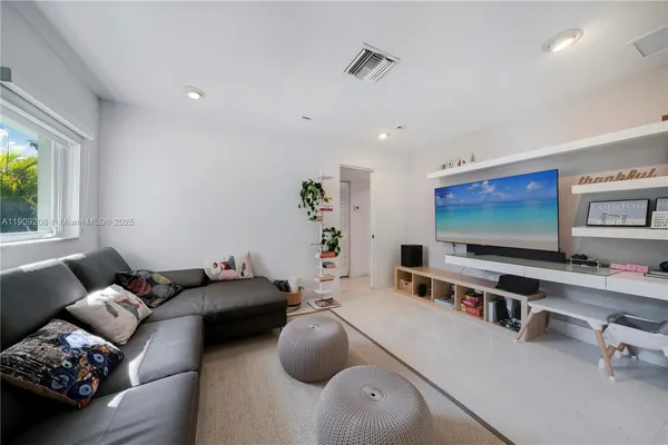a living room with furniture and a potted plant