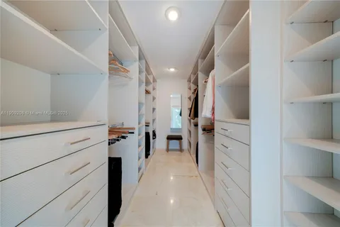 a spacious bedroom with a bed a couch and a flat screen tv