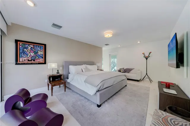 a bed room with a bed and a chair