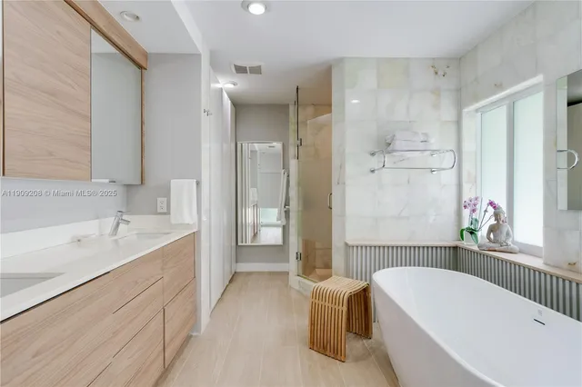 a bathroom with a bathtub and a shower