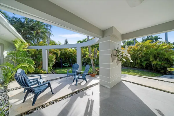 a view of a house with backyard porch and sitting area