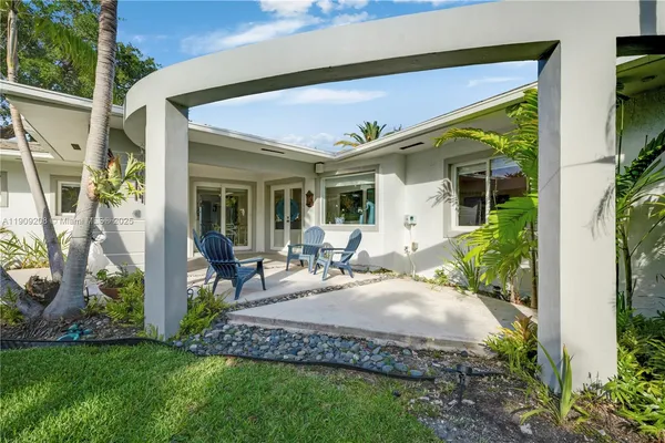 a view of a house with pool and chairs