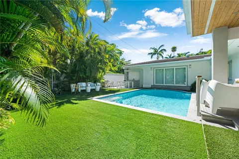 a view of a house with a backyard porch and sitting area