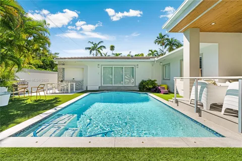 a view of a swimming pool with sitting area