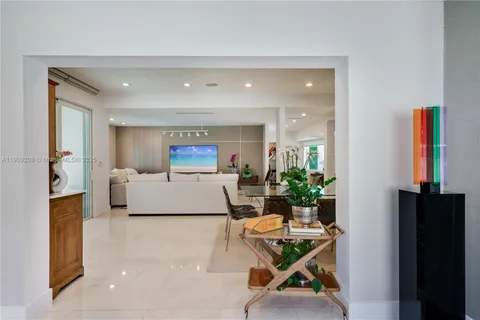 a view of a dining room with furniture one side and wooden floor