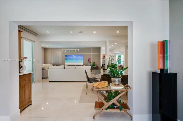 a view of a dining room with furniture one side and wooden floor