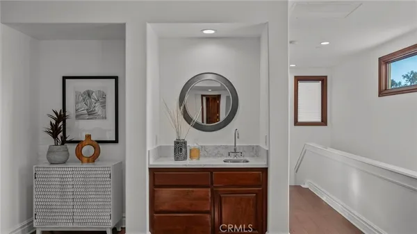 a kitchen with a sink a potted plant and cabinets