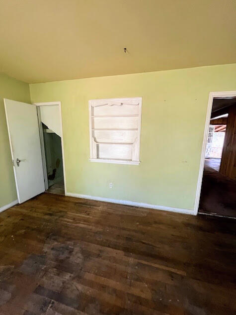 2417 27th Street Lubbock, TX 79411 - Photo 3 of 25 a view of an empty room with wooden floor and a window