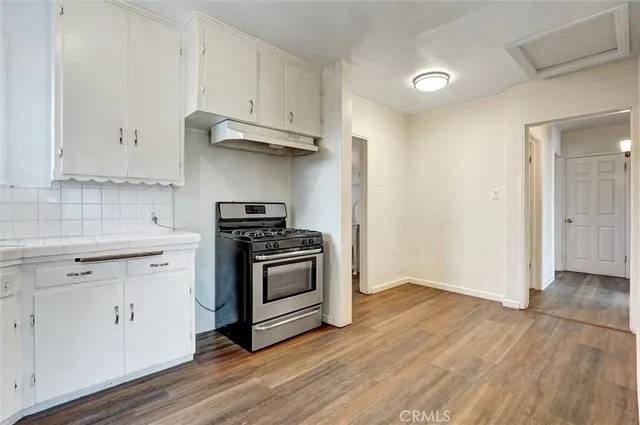 a kitchen with granite countertop a stove and a sink