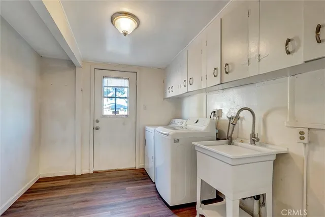 a view of a kitchen with sink and cabinets