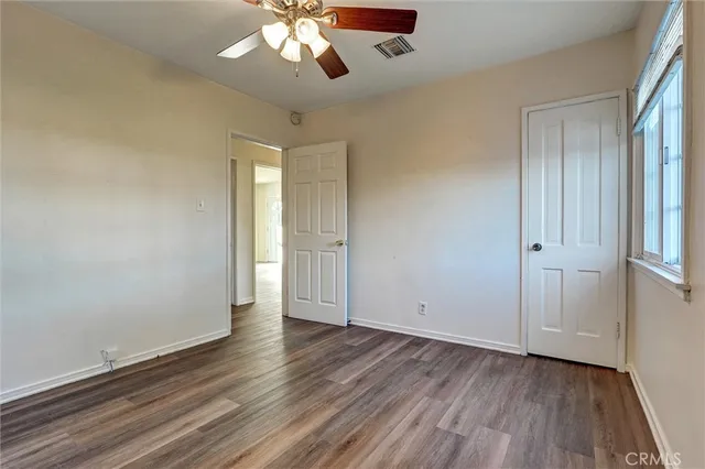 wooden floor in an empty room with a window