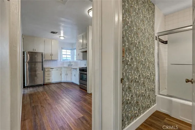 a kitchen with a refrigerator and a stove top oven
