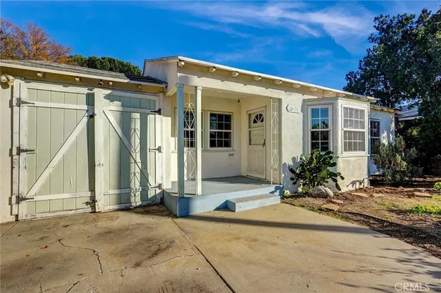 a view of a house with potted plants