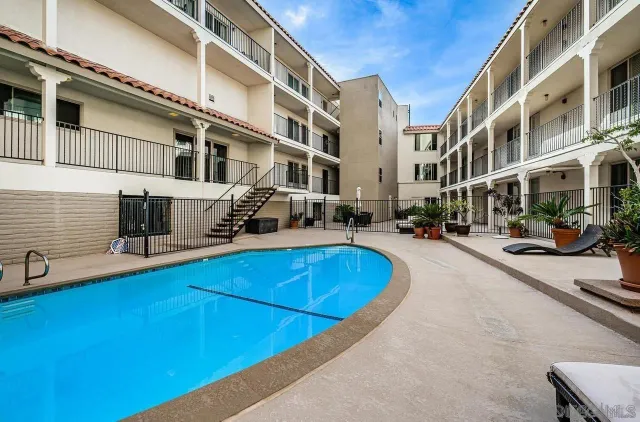 a view of a building with cars parked