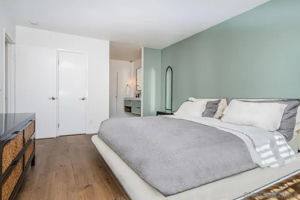 a bedroom with a bed and a flat screen tv
