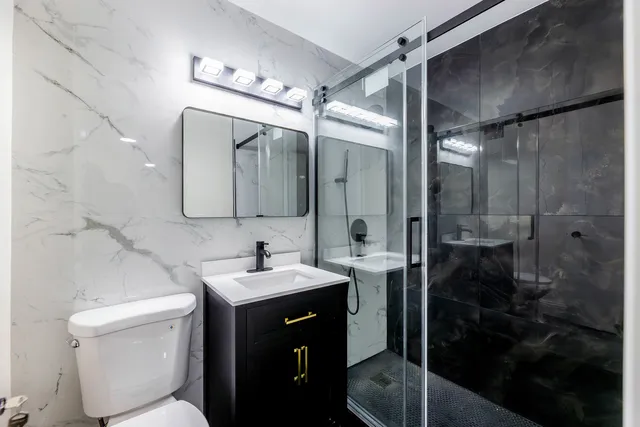 a bathroom with a sink toilet and shower