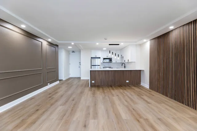 a large kitchen with kitchen island a sink stainless steel appliances and cabinets