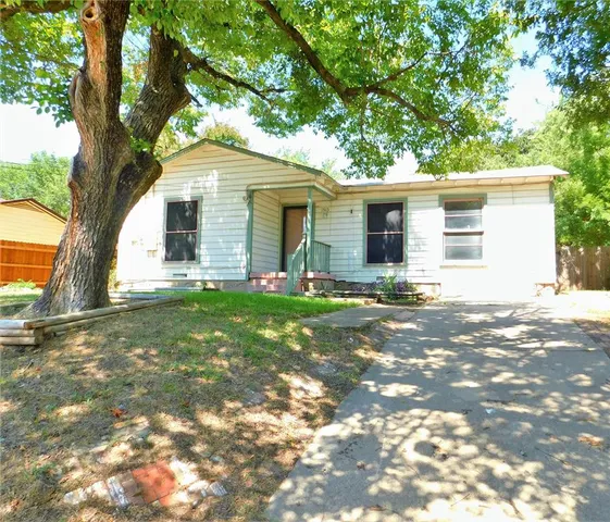 a backyard of a house with yard and outdoor seating