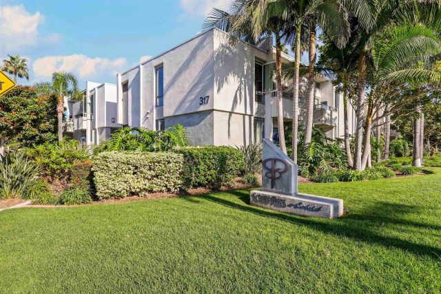 a garden with trees in front of it