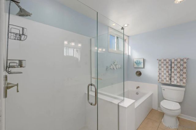 a bathroom with a shower a toilet and a shower