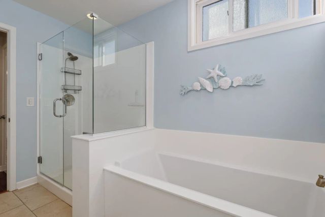 a bathroom with a bathtub and a shower