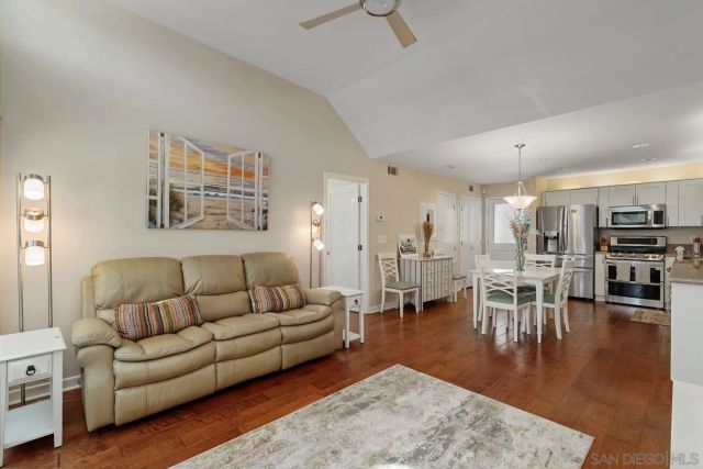 a living room with furniture wooden floor and a table