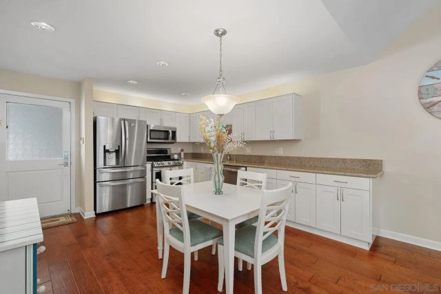 a kitchen with refrigerator cabinets dining table and chairs