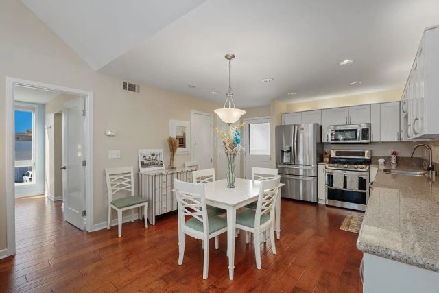 a view of a dining room kitchen with furniture and wooden floor