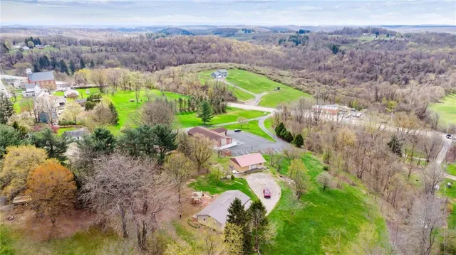 an aerial view of a houses with a yard