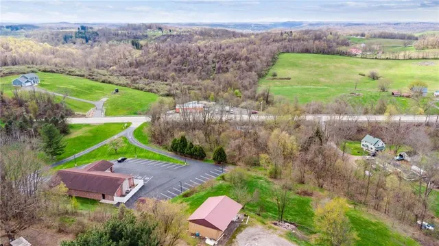 an aerial view of a house with a garden and a yard