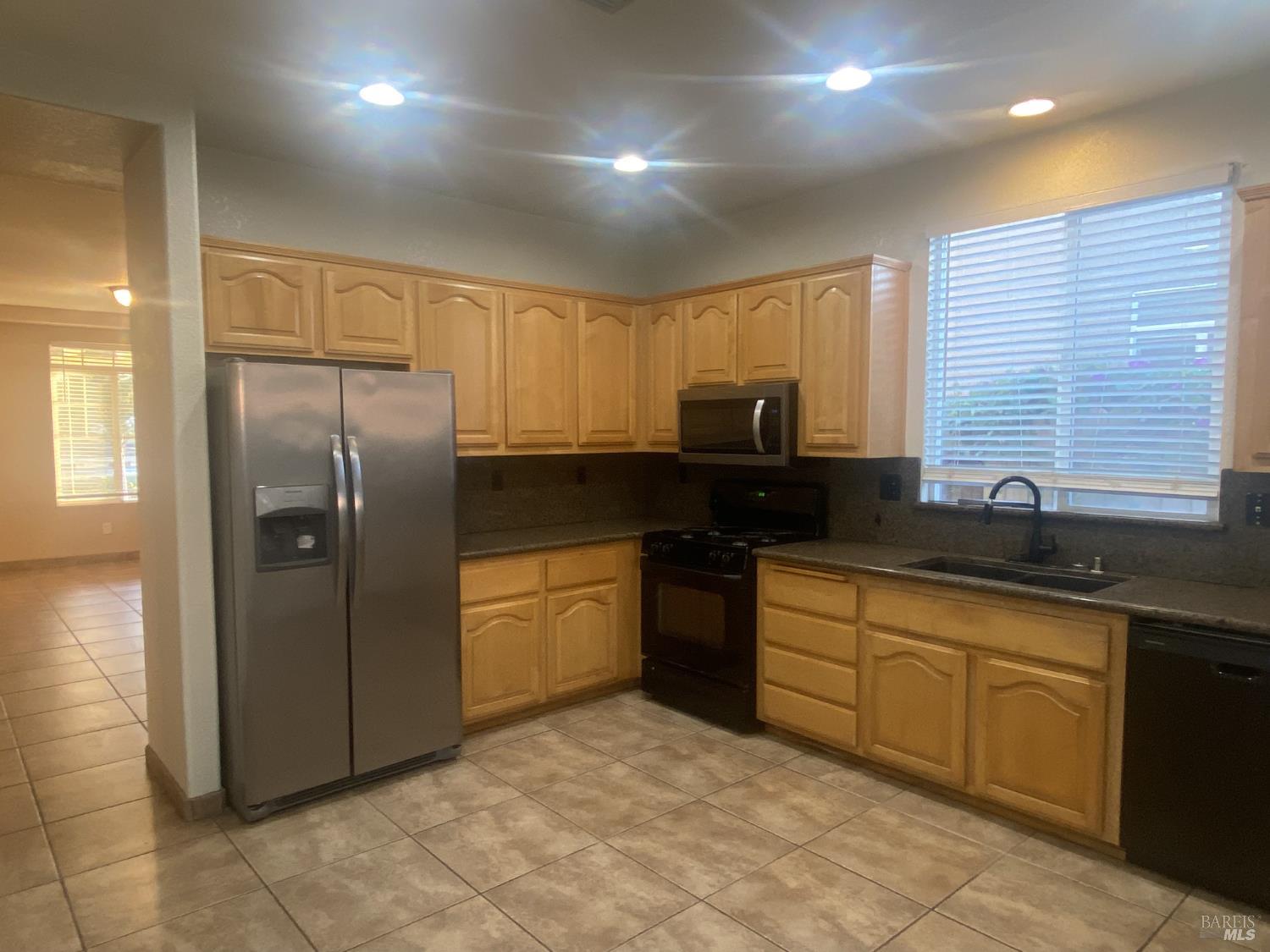 706 Anderson Way Rio Vista, CA 94571 - Photo 4 of 13 a kitchen with stainless steel appliances granite countertop a refrigerator and a sink