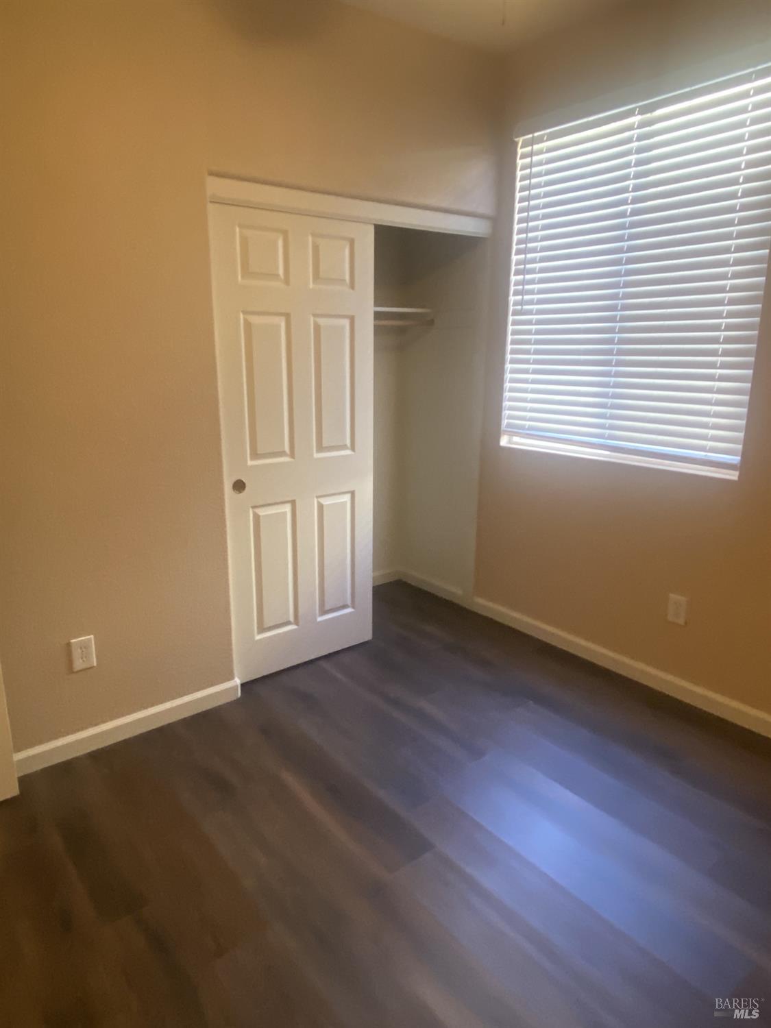 706 Anderson Way Rio Vista, CA 94571 - Photo 6 of 13 an empty room with wooden floor and windows