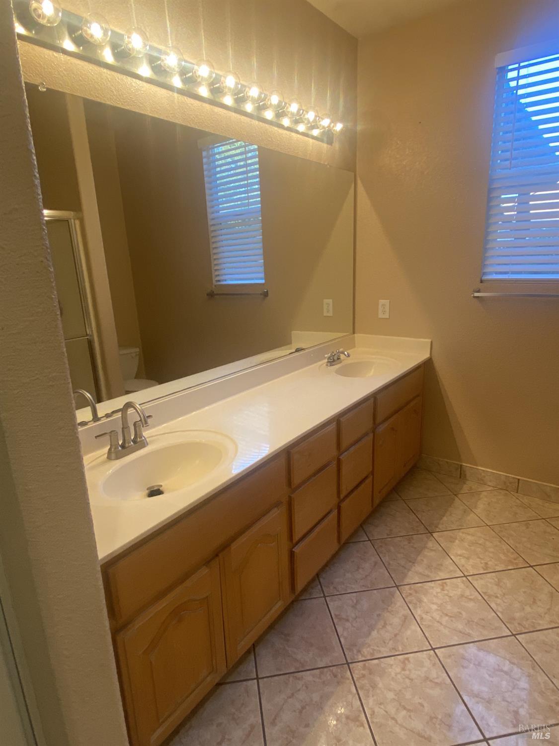 706 Anderson Way Rio Vista, CA 94571 - Photo 7 of 13 a bathroom with a double vanity sink and a mirror
