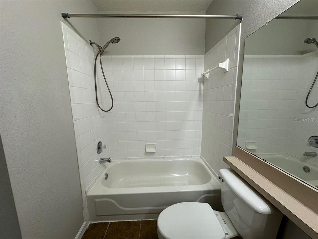 4348 South Kirkman Road, Unit 812 Orlando, FL 32811 - Photo 14 of 22 a bathroom with a sink a toilet and shower