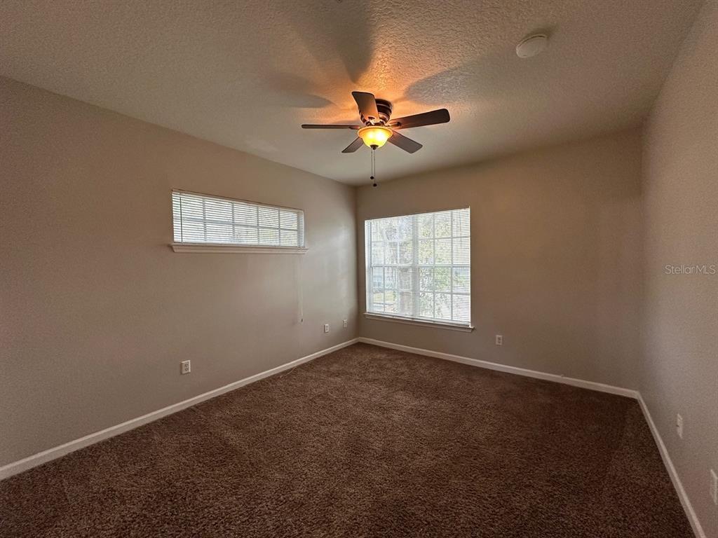 4348 South Kirkman Road, Unit 812 Orlando, FL 32811 - Photo 16 of 22 an empty room with windows and fan