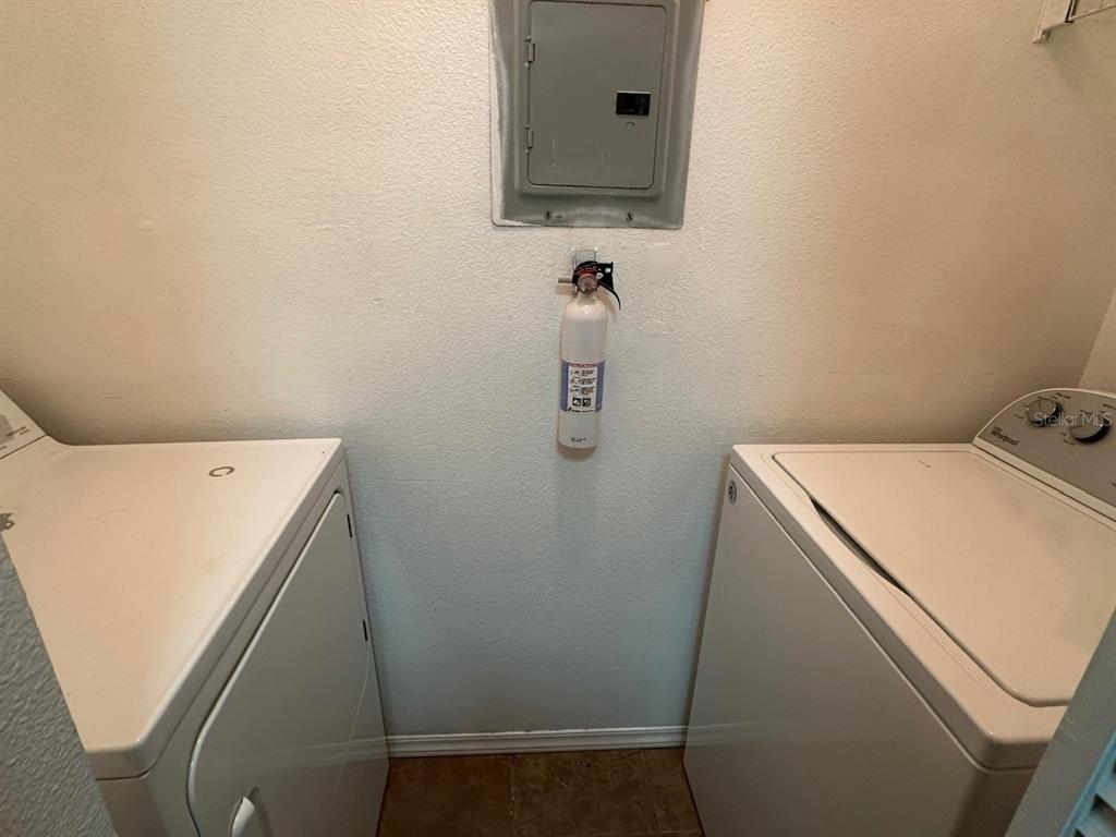 4348 South Kirkman Road, Unit 812 Orlando, FL 32811 - Photo 6 of 22 a utility room with dryer and washer