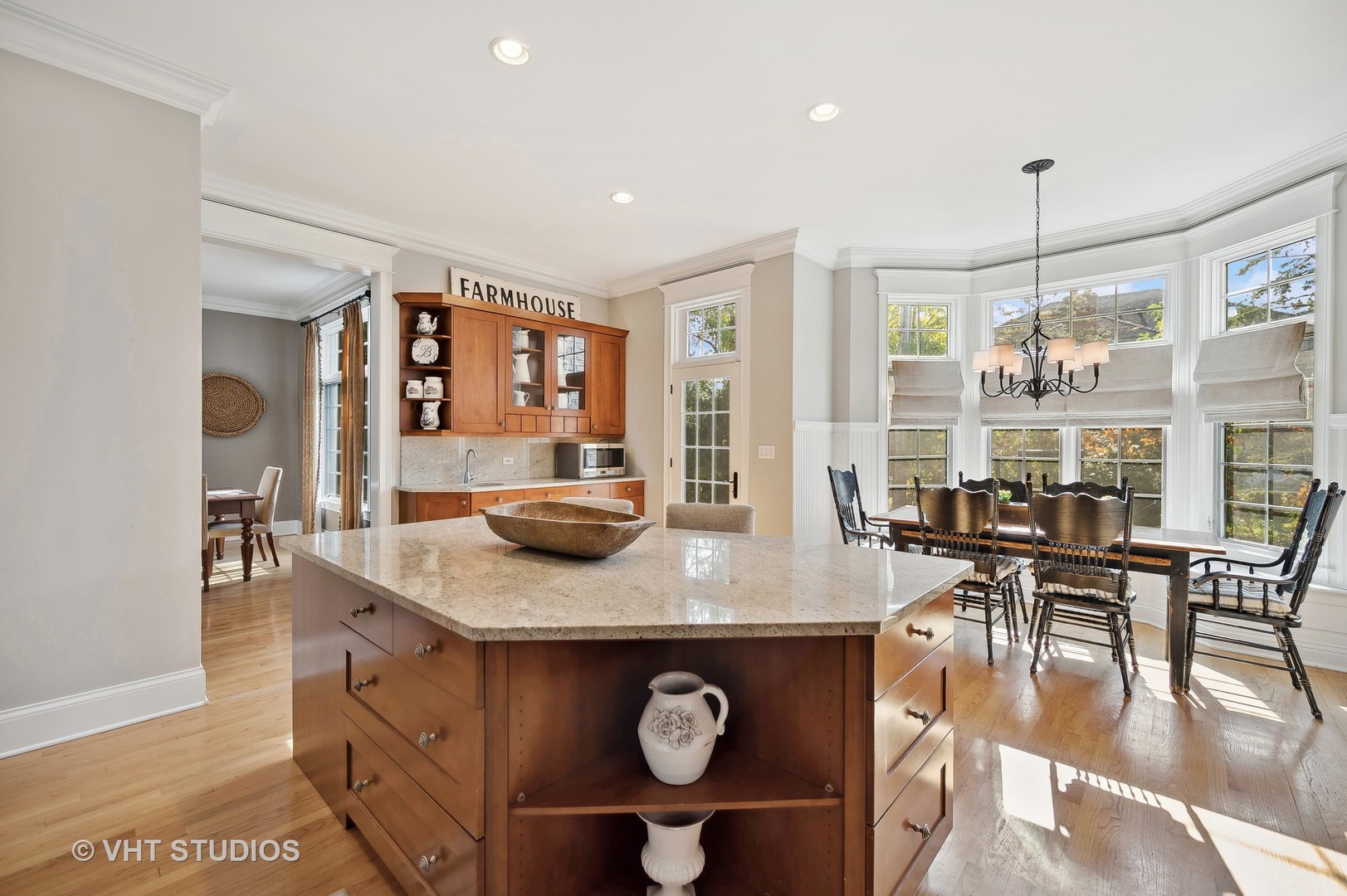 907 Queens Lane Glenview, IL 60025 - Photo 11 of 39 a view of kitchen island a dining table chairs and couches
