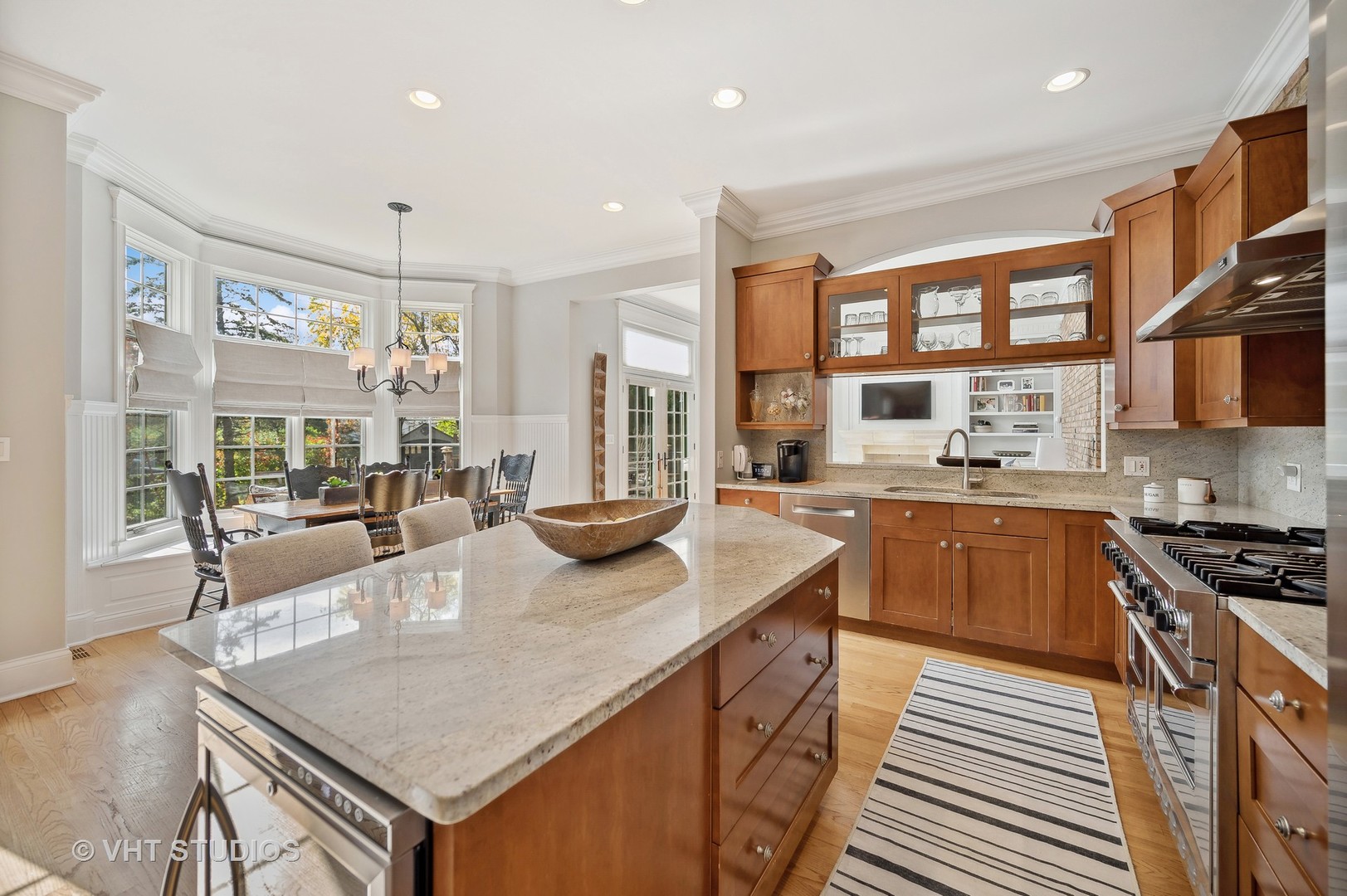 907 Queens Lane Glenview, IL 60025 - Photo 12 of 39 a kitchen with stainless steel appliances granite countertop a kitchen island a stove and a sink