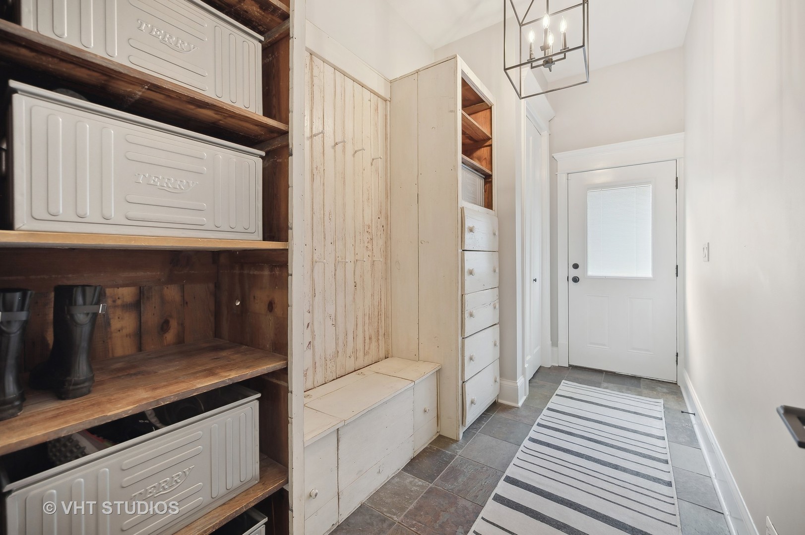 907 Queens Lane Glenview, IL 60025 - Photo 19 of 39 a view of a hallway with wooden cabinets and staircase
