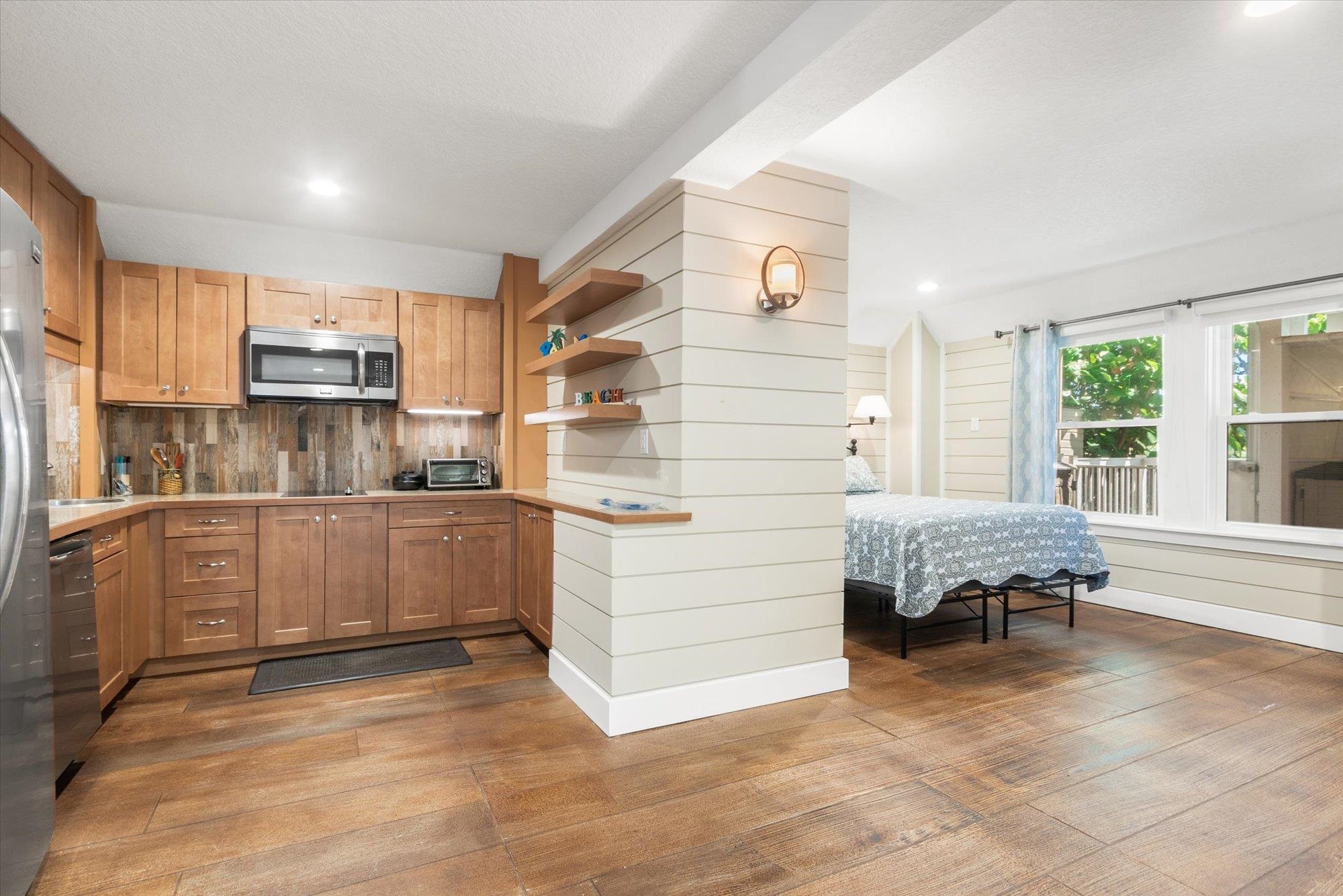 1 2nd Lane St. Augustine, FL 32080 - Photo 47 of 86 Kitchen featuring light countertops, dark wood-type flooring, tasteful backsplash, brown cabinetry, and recessed lighting